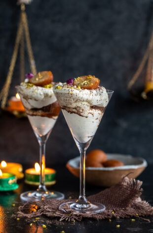 gulab jamun fusion dessert arranged in martini glasses with diyas in the background