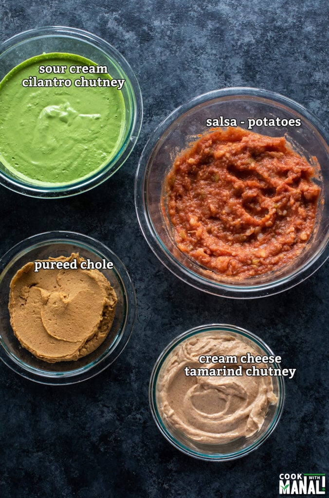 bowls with cilantro chutney, tamarind chutney, salsa and pureed chole