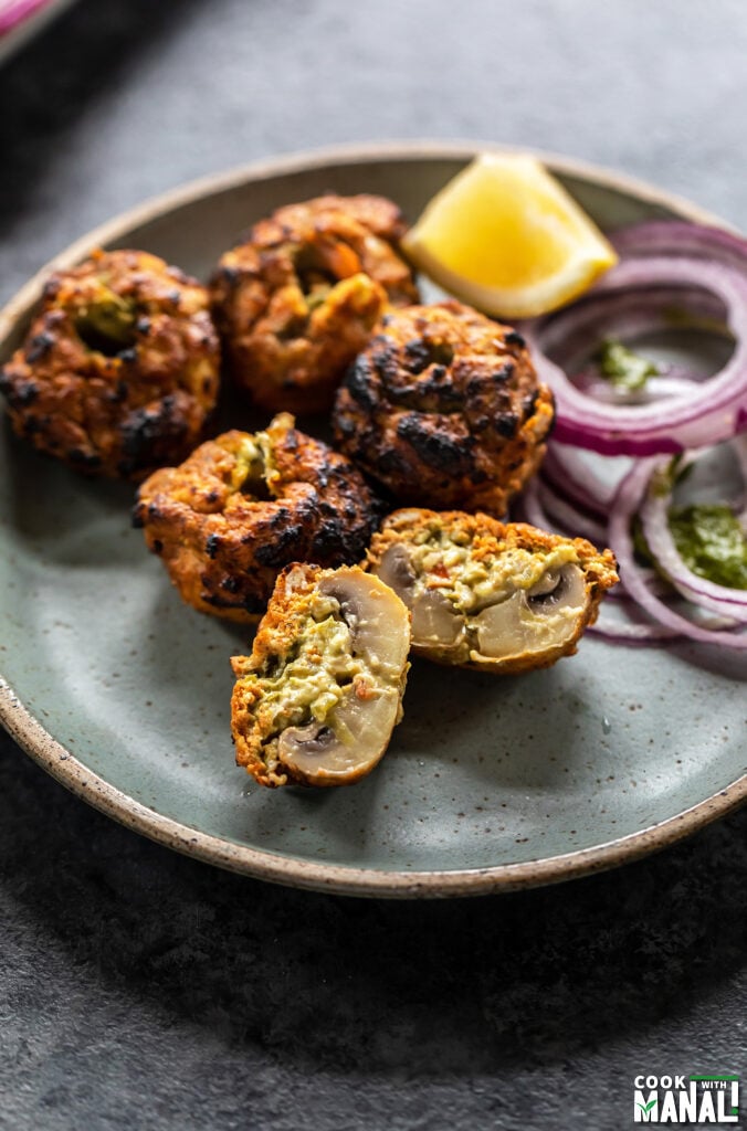 tandoori mushroom sliced in half to show the stuffing