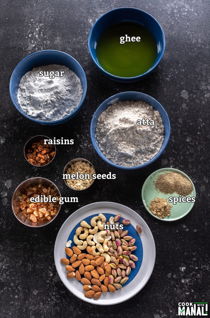 ingredients for making atta pinni arranged on a board