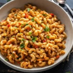 masala macaroni served in a bowl and garnished with cilantro