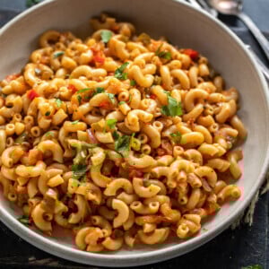 masala macaroni served in a bowl and garnished with cilantro
