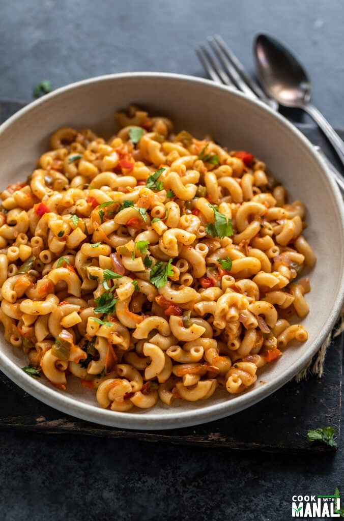 masala macaroni served in a bowl and garnished with cilantro