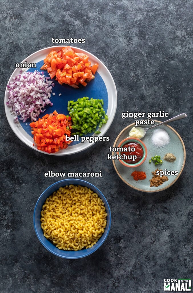 ingredients for masala macaroni arranged on a board