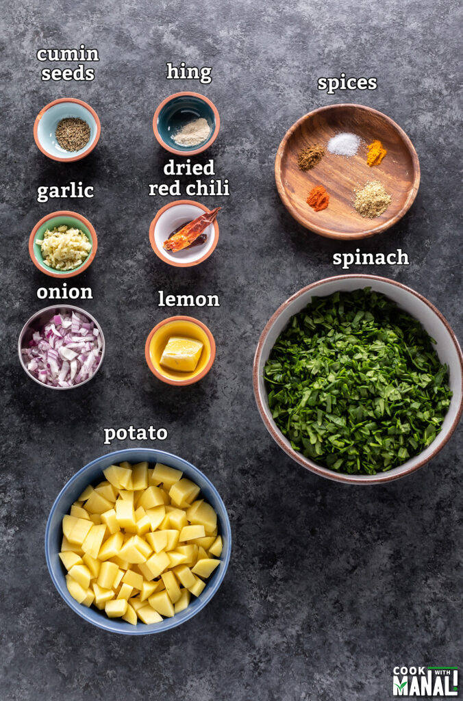 ingredients required for aloo palak arranged on a board