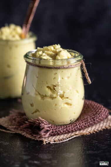 ginger garlic paste placed in a wide mouth glass bottle and the neck of the bottle is tied with a jute string.