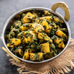 aloo palak served in a copper kadai