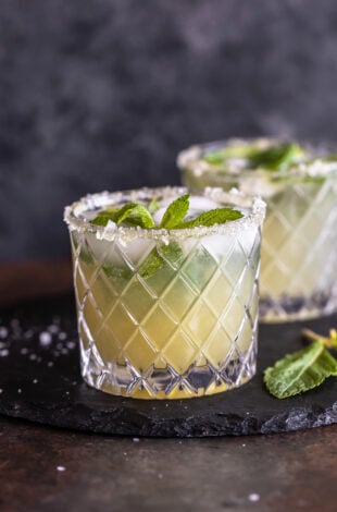 cucumber mocktail served in a glass which has salt flakes on the rim and garnished with mint leaves