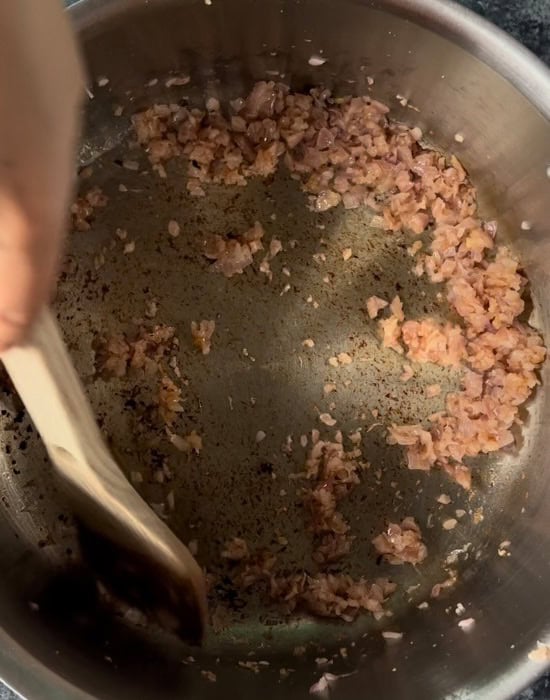 caramelized onions stirred in a steel pot
