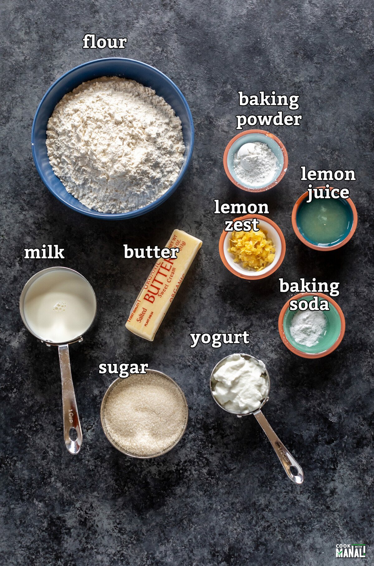 ingredients to make a  lemon cake arranged on a board