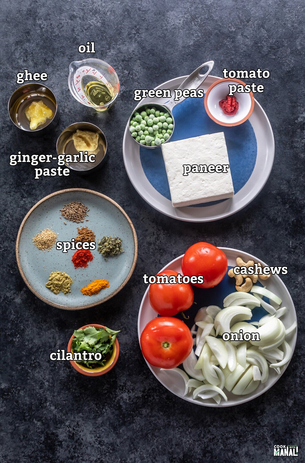 ingredients for making matar paneer arranged on a board