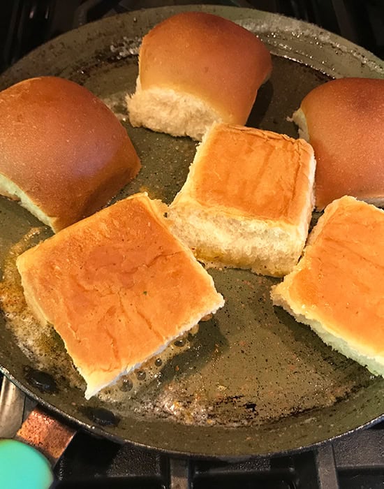 sliced buns placed on a tawa