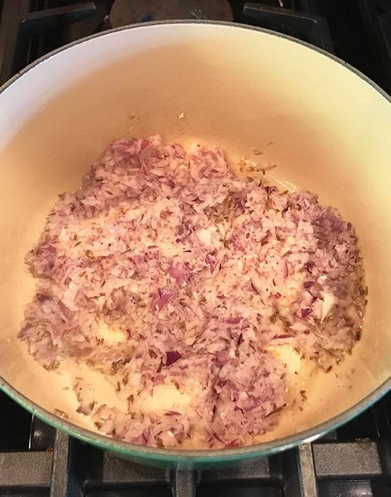chopped onions being sauteed in a pot