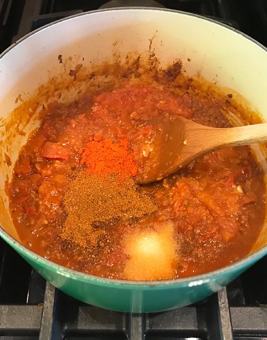 powdered spices added to masala base in a pot