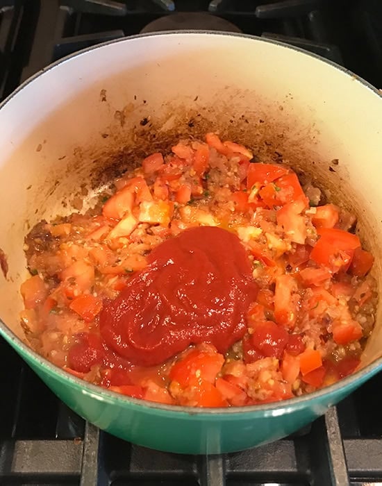 chopped tomatoes with added tomato puree in a pot