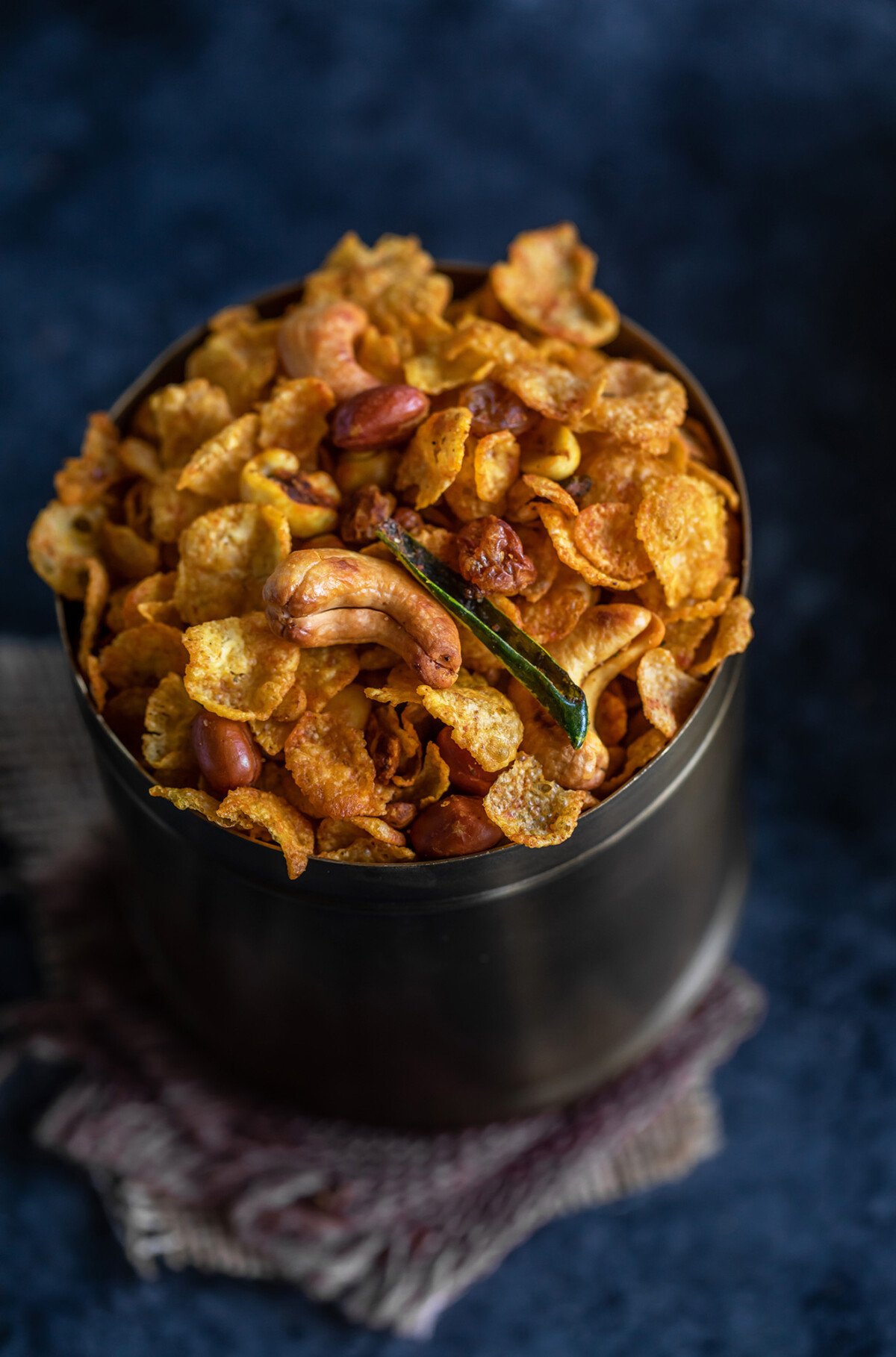 cornflakes chivda served in a copper container