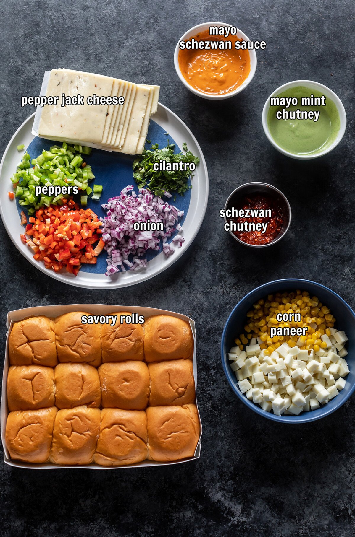 ingredients for making schezwan paneer sliders arranged on board