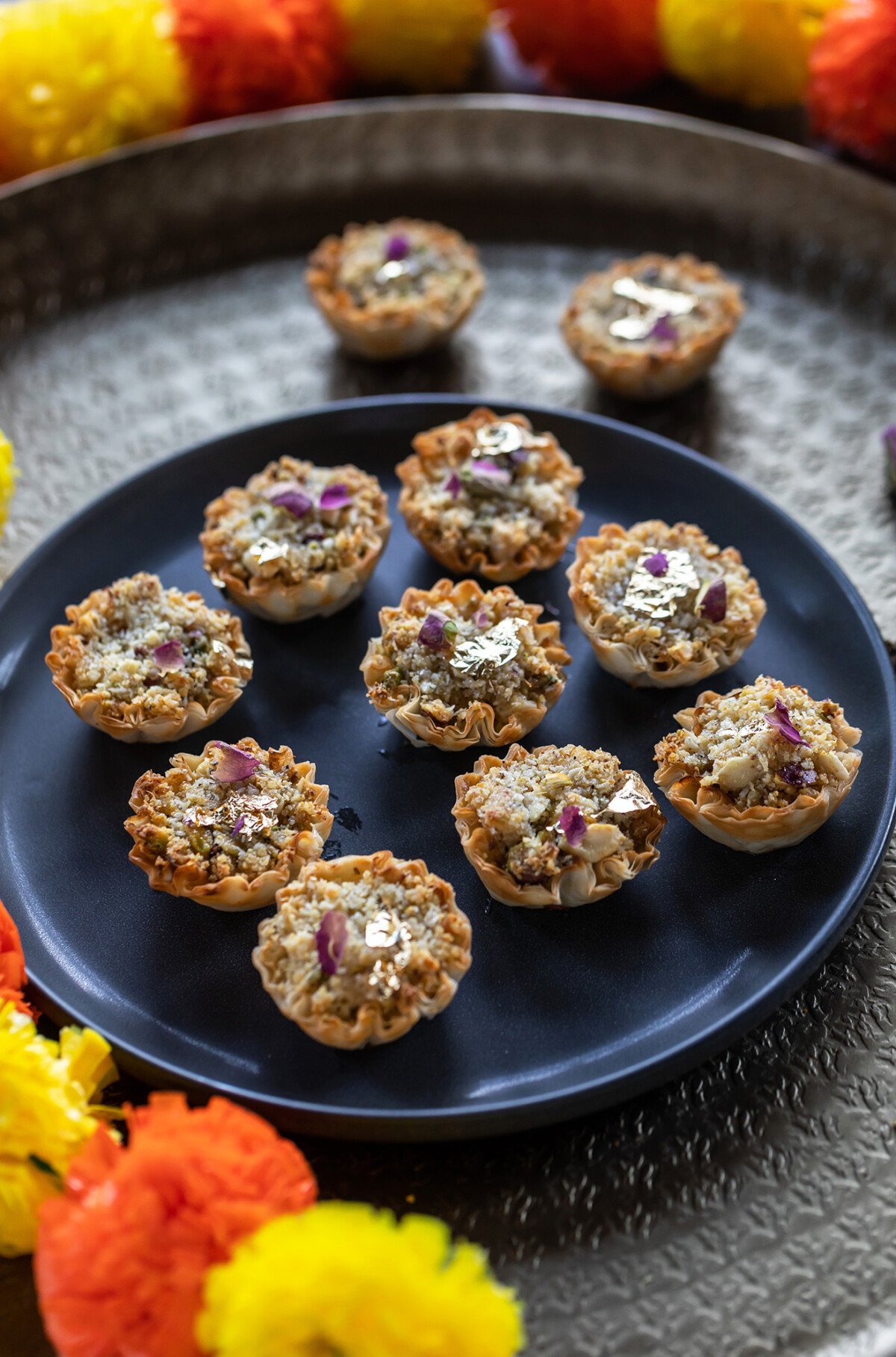 baklava cups arranged on a golden color plate