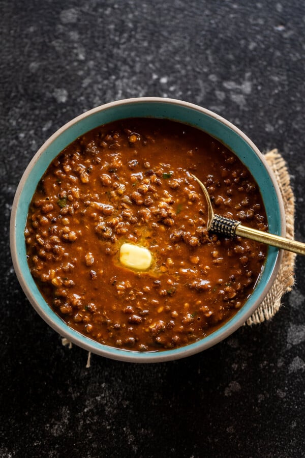 urad dal served with butter in a blue color bowl