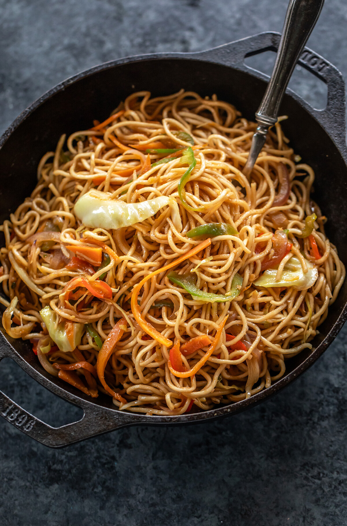 veg chowmein served in a small black iron wok