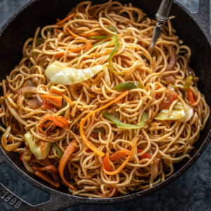 veg chowmein served in a small black iron wok