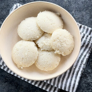 steamed idlis served in a white bowl