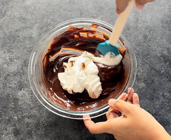 whipped cream being folded into the ganache