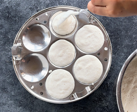 batter being added to idli molds