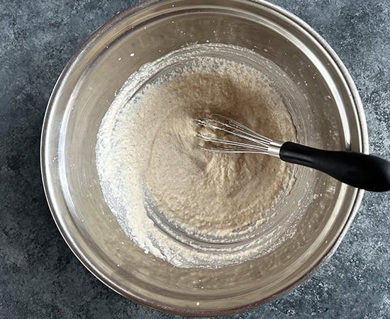 a wire whisking yogurt and semolina