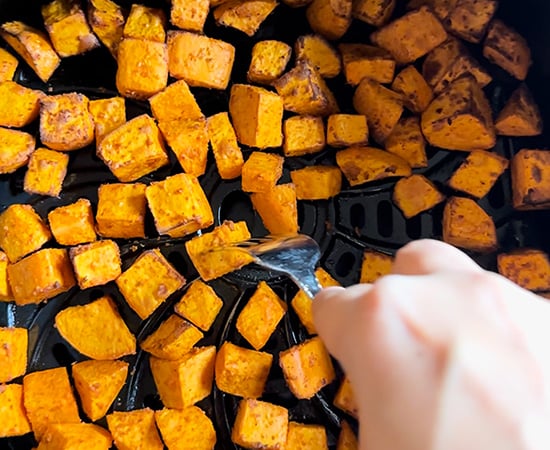 sweet potato being pricked with a fork