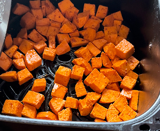 sweet potato cubes arranged in an air fryer