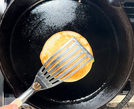 uttapam with being pressed with a spatula