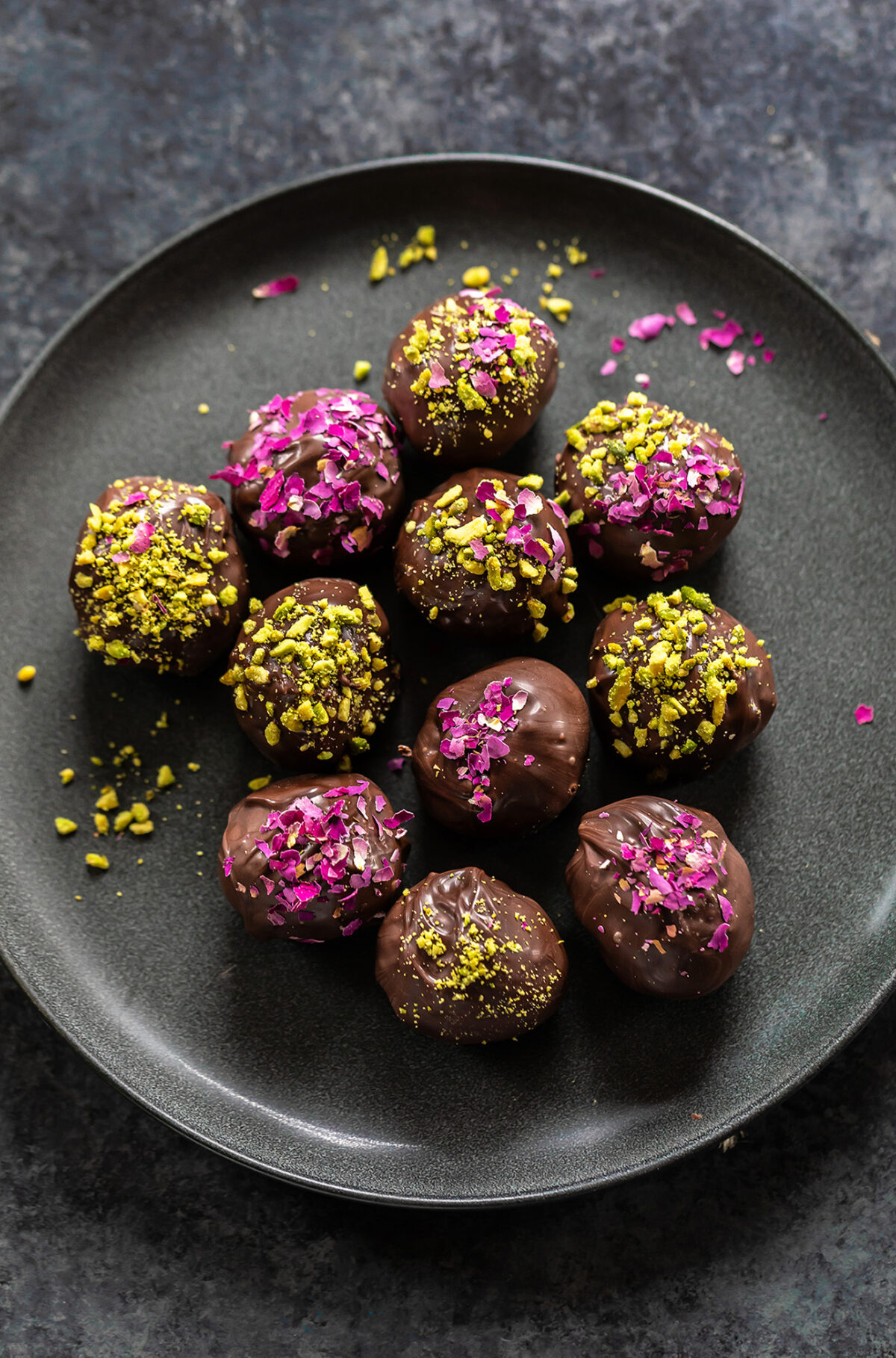 gujiya truffles coated with dried rose petals and crushed pistachios