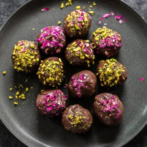 gujiya truffles coated with dried rose petals and crushed pistachios