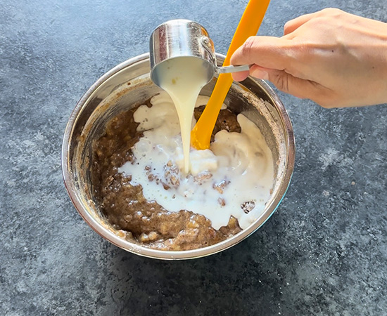 milk being added to a bowl