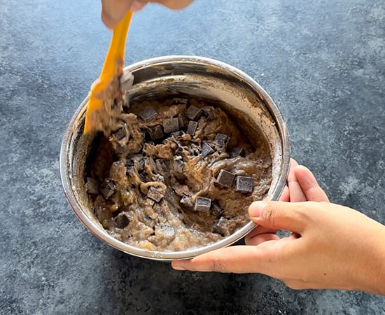 chocolate chunks being folded into batter