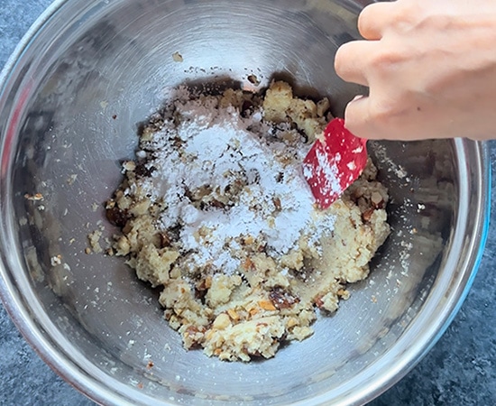 powdered sugar being added to bowl of mawa