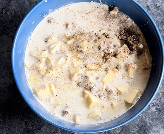 heavy cream poured over chopped white chocolate in a bowl