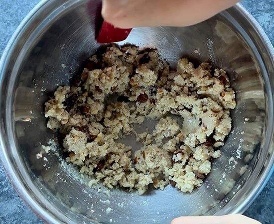 mixing mawa and nuts together using a spatula