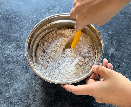 mixing dry flour into wet ingredients