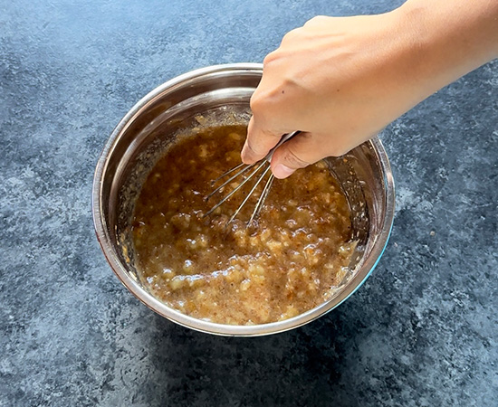 mixing wet ingredients for a muffin with a wire whisk