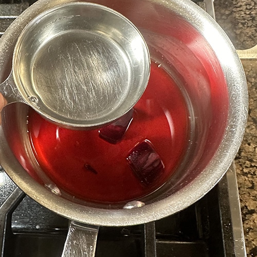 vinegar being added to water in a pan