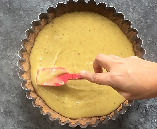 tart filling being spread with a spatula
