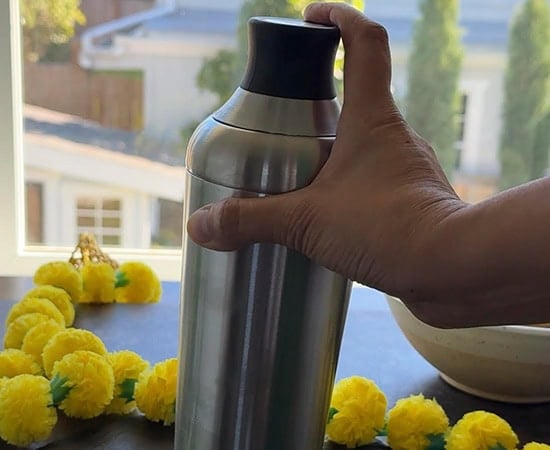 hand holding a cocktail shaker