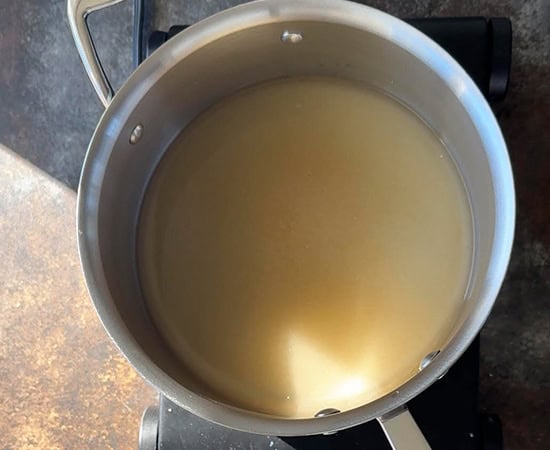 water and sugar in a steel pan
