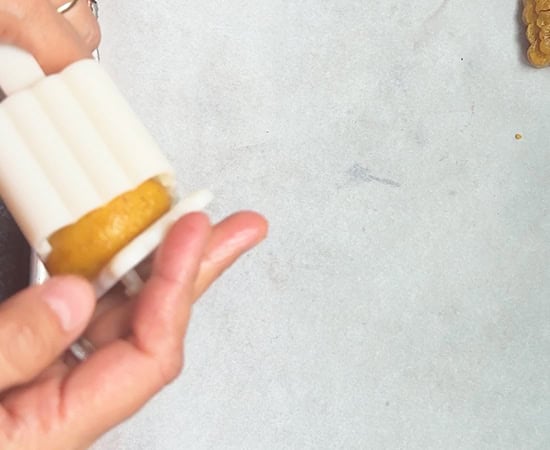 mixture being pressed inside a mooncake mold