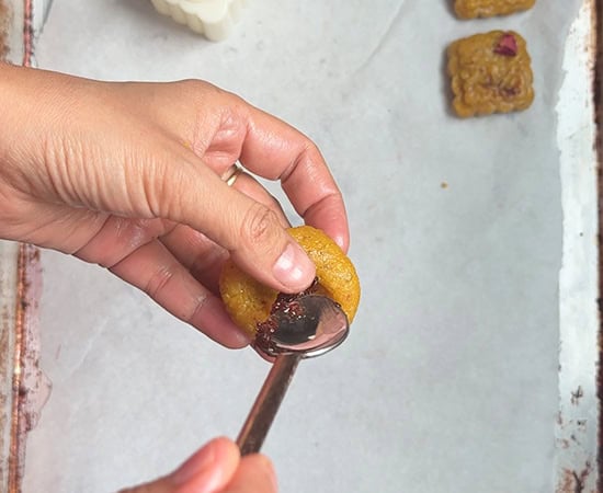 peda being filled with the help of a spoon