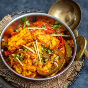 paneer dish garnished with ginger juliennes served in copper kadai