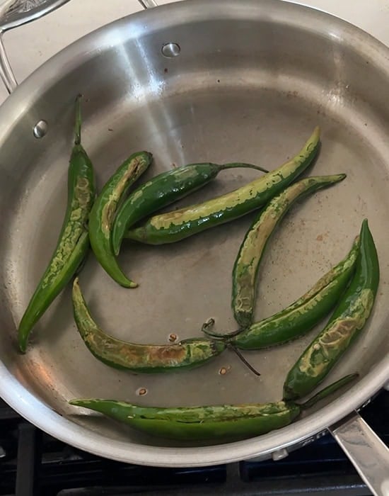long green chilies spluttering in oil
