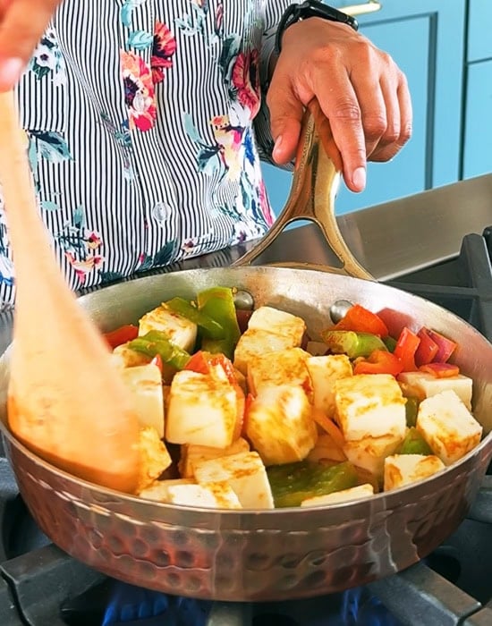 paneer being pan fried with onions and peppers